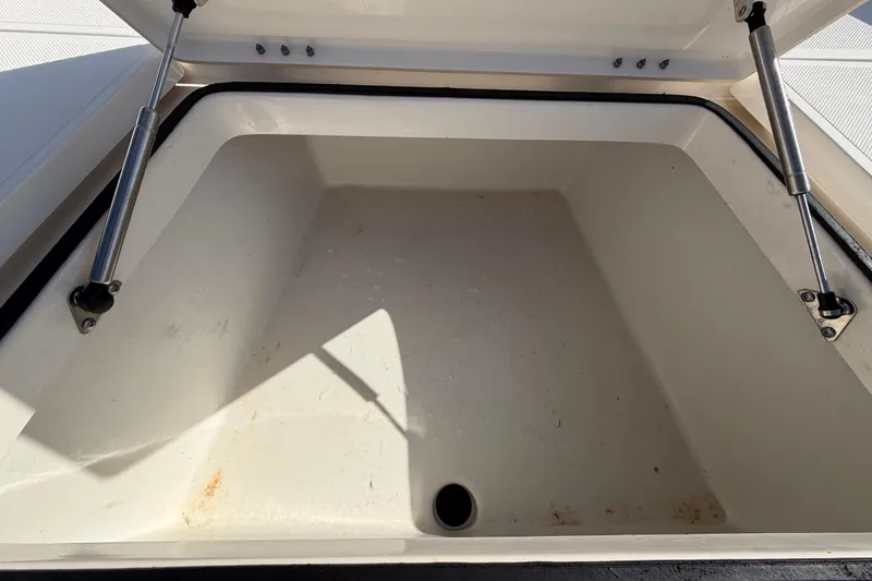 Slide: The Image of 2014 Skeeter SX2250 boat deck with storage compartment and logo. - 39