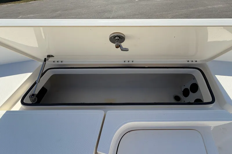 Slide: The Image of Open storage compartment of 2014 Skeeter SX2250 boat, showing interior details. - 41