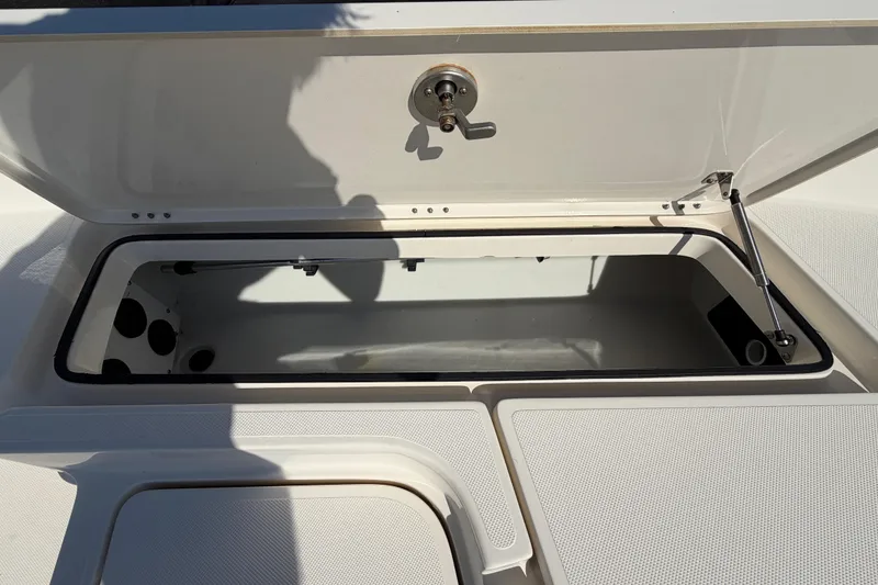 Slide: The Image of 2014 Skeeter SX2250 boat storage compartment with open hatch and latch. - 44