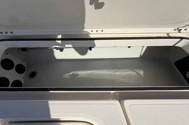 Slide: The Image of 2014 Skeeter SX2250 boat deck with storage compartment and coiled cables. - 45