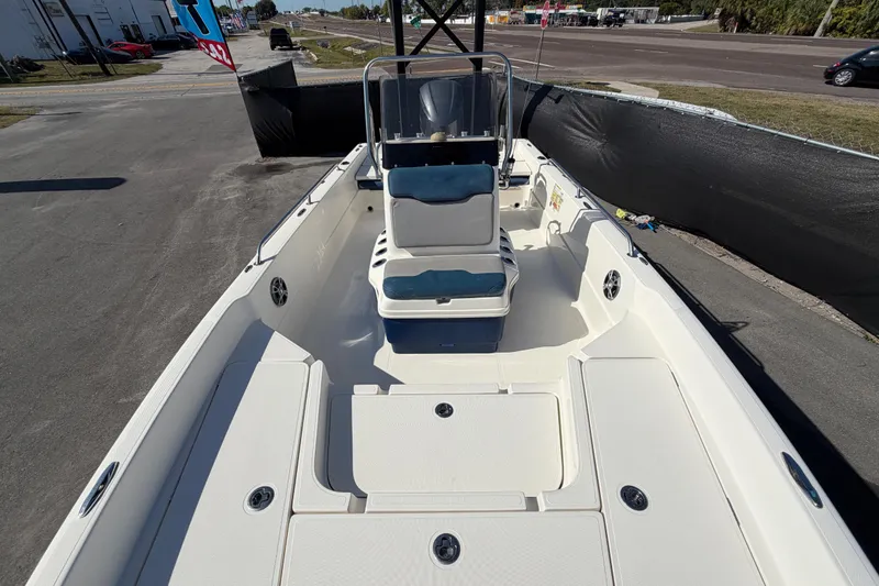 Slide: The Image of Open storage compartment on 2014 Skeeter SX2250 boat, featuring a blue cushioned lid. - 53