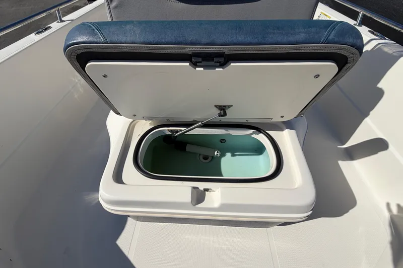 Slide: The Image of 2014 Skeeter SX2250 boat wiring compartment with cables and electrical components. - 57