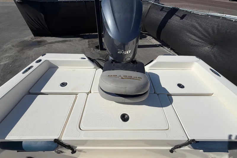Slide: The Image of 2014 Skeeter SX2250 boat deck with cushioned seating and storage compartment. - 64