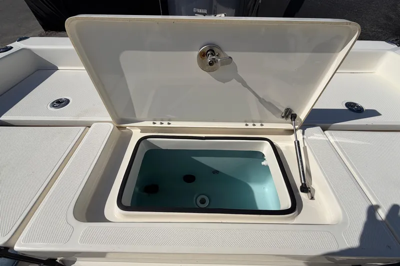 Slide: The Image of 2014 Skeeter SX2250 boat seat, blue and gray upholstery, on deck. - 74