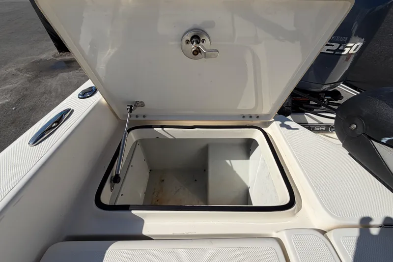 Slide: The Image of Livewell compartment of a 2014 Skeeter SX2250 boat, partially filled with water. - 77