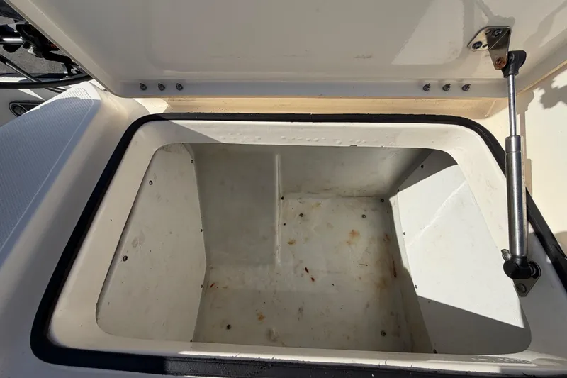 Slide: The Image of 2014 Skeeter SX2250 boat interior with open storage compartment and seating. - 81