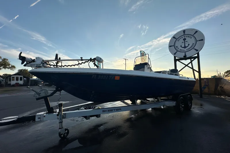 Slide: The Image of 2014 Skeeter SX2250 boat on trailer under cloudy sky at dealership. - 9