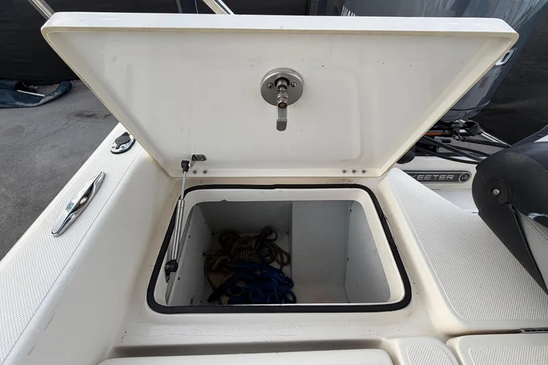 Slide: The Image of Trailer wheels of a 2014 Skeeter SX2250 boat on pavement. - 90