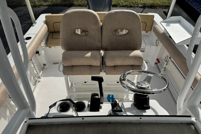 Slide: The Image of 2020 Sportsman Heritage 231 Center Console boat interior with dual seats and steering wheel. - 10
