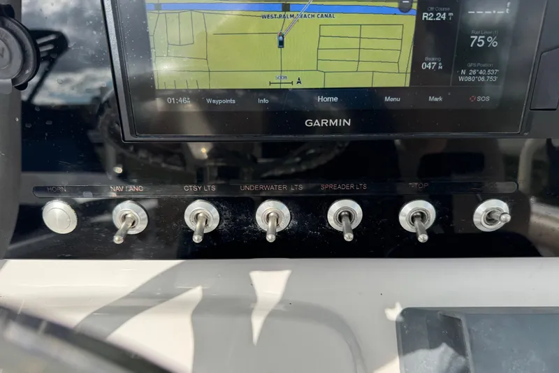Slide: The Image of Control panel of a 2020 Sportsman Heritage 231 Center Console with Garmin display and switches. - 12