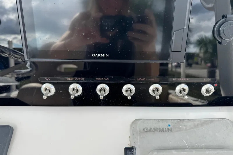 Slide: The Image of Control panel of 2020 Sportsman Heritage 231 Center Console with Garmin display and switches. - 13