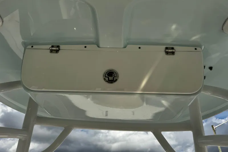 Slide: The Image of 2020 Sportsman Heritage 231 Center Console storage compartment under cloudy sky. - 21