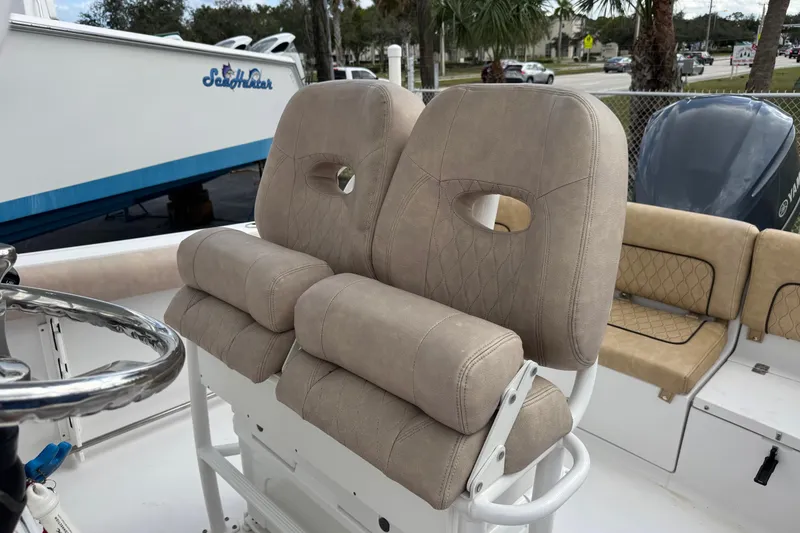 Slide: The Image of 2020 Sportsman Heritage 231 Center Console boat with beige cushioned seating. - 24