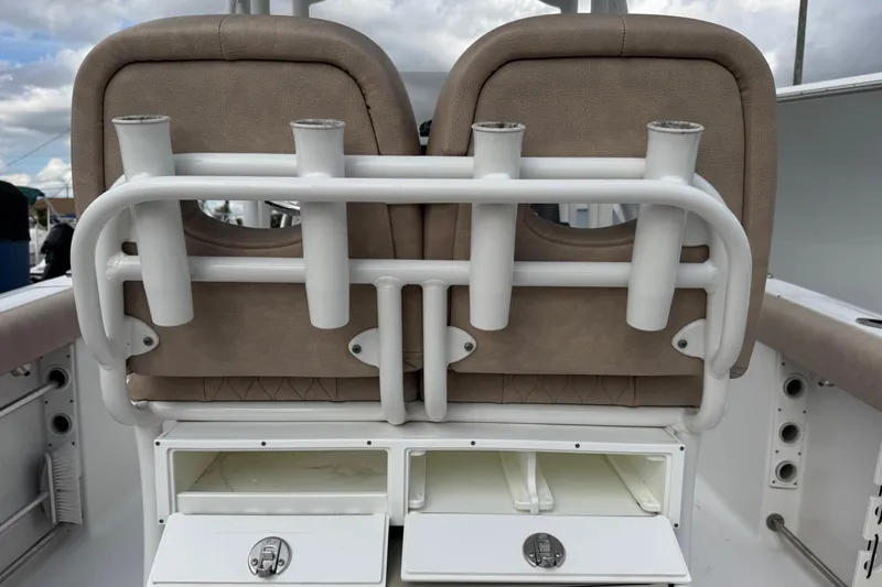 Slide: The Image of 2020 Sportsman Heritage 231 Center Console boat seating with rod holders and storage compartments. - 25