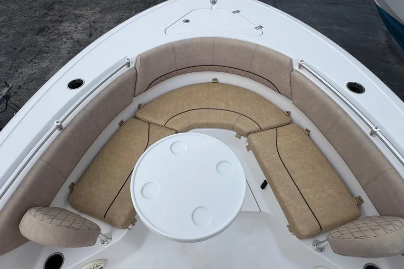 Slide: The Image of 2020 Sportsman Heritage 231 Center Console boat with cushioned seating and round table. - 27