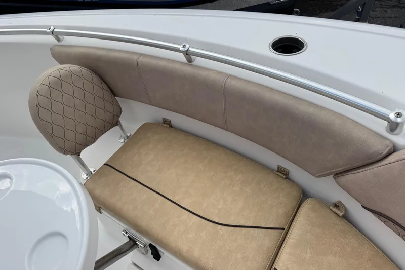 Slide: The Image of 2020 Sportsman Heritage 231 Center Console boat seating with beige cushions and stainless steel rail. - 30
