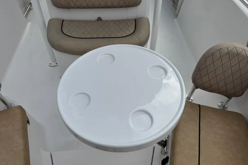 Slide: The Image of 2020 Sportsman Heritage 231 Center Console interior with round table and cushioned seating. - 31