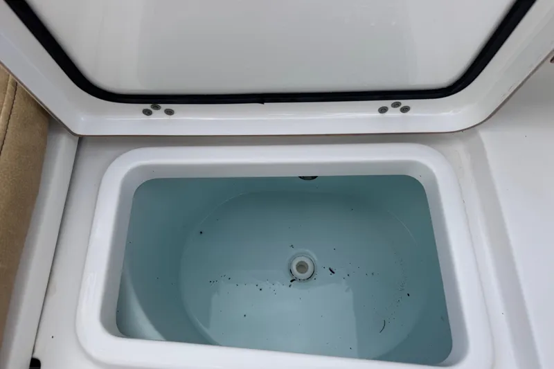 Slide: The Image of Open storage compartment on 2020 Sportsman Heritage 231 Center Console boat. - 42