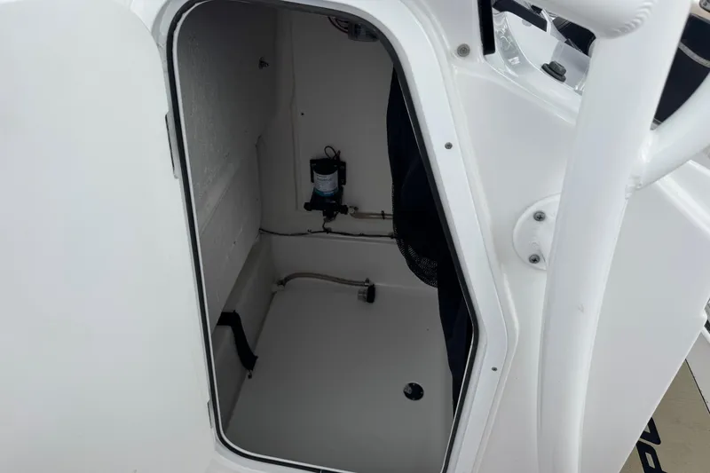 Slide: The Image of 2020 Sportsman Heritage 231 Center Console storage compartment interior view. - 46