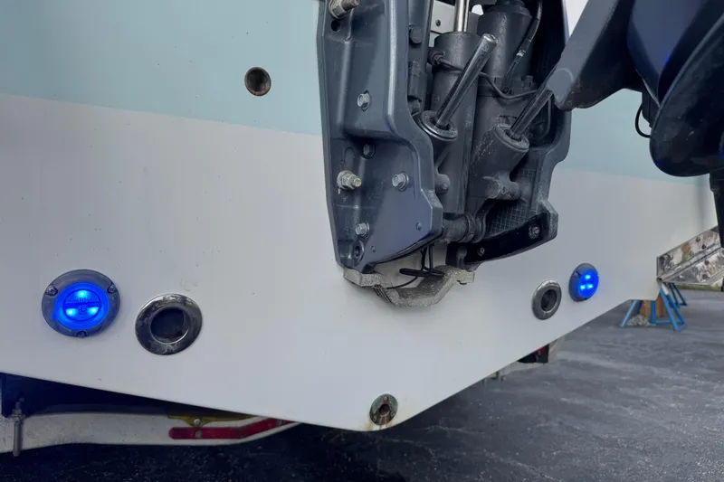 Slide: The Image of 2020 Sportsman Heritage 231 Center Console boat with blue LED lights and motor detail. - 47