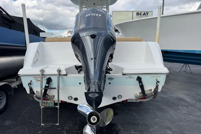 Slide: The Image of 2020 Sportsman Heritage 231 Center Console boat with powerful outboard motor, parked at a marina. - 49