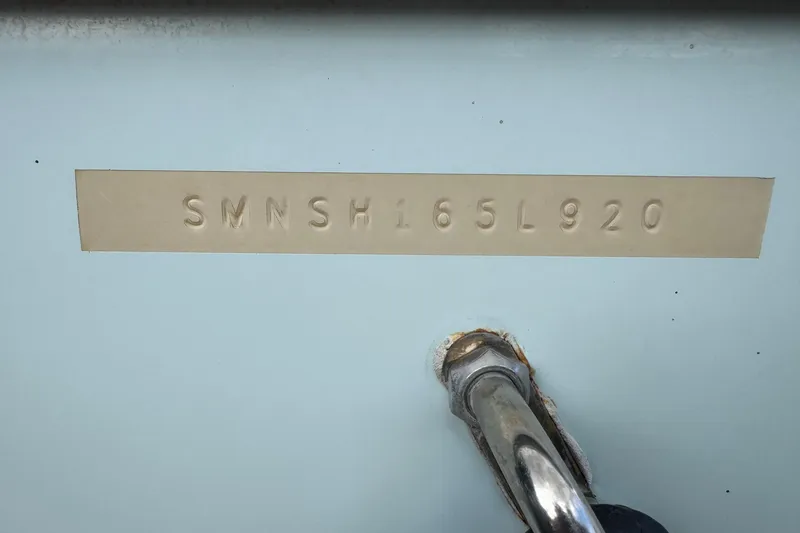 Slide: The Image of 2020 Sportsman Heritage 231 Center Console hull identification number (HIN) on light blue surface. - 52