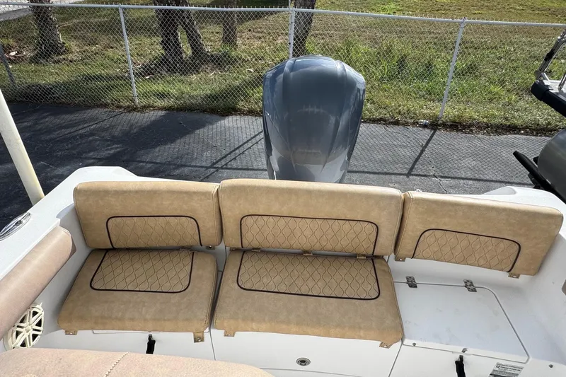 Slide: The Image of 2020 Sportsman Heritage 231 Center Console boat with cushioned seating and outboard motor. - 6