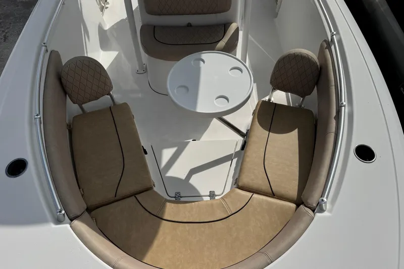 Slide: The Image of 2020 Sportsman Heritage 231 Center Console boat with cushioned seating and round table. - 8