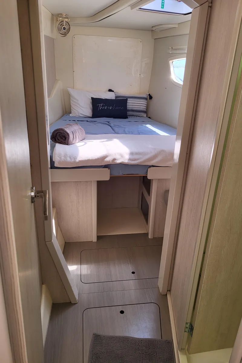 Slide: The Image of Interior of a Leopard 44 yacht, bedroom with bed and window. - 15