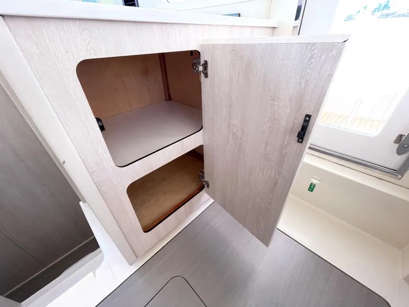 Slide: The Image of Open cabinet inside a 2016 Leopard 44 yacht interior. - 33