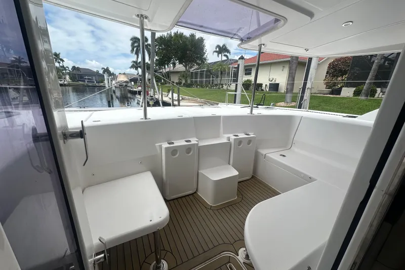 Slide: The Image of 2016 Leopard 44 yacht cockpit with seating, docked by waterfront homes. - 40