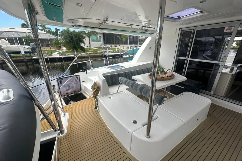 Slide: The Image of 2016 Leopard 44 yacht interior with seating area and table, docked at marina. - 47