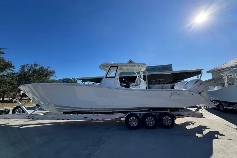 The Image of 2026 Yellowfin 36 Offshore boat on trailer under clear blue sky. - 1