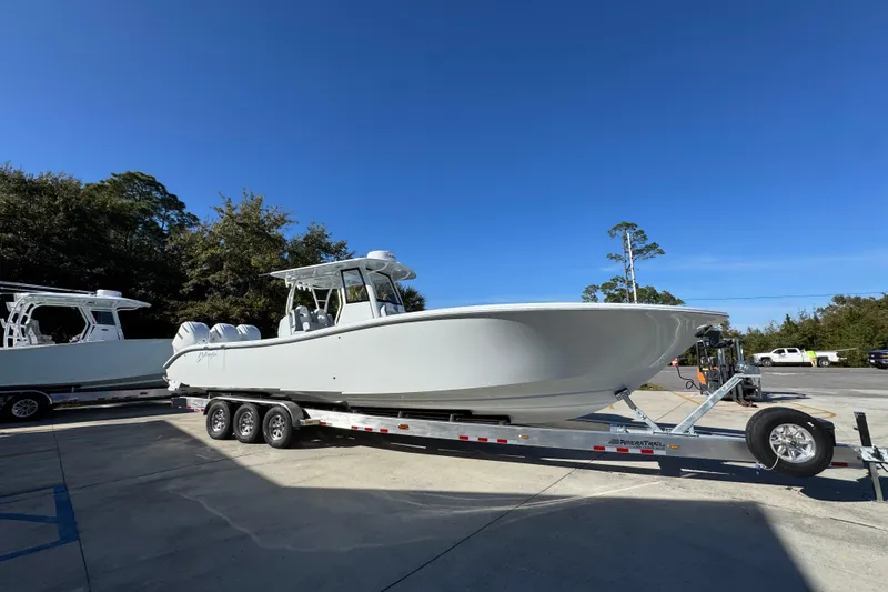 Slide: The Image of 2026 Yellowfin 36 Offshore boat on trailer under clear blue sky. - 10