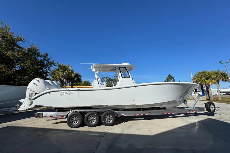 Slide: The Image of 2026 Yellowfin 36 Offshore boat on trailer, clear sky background. - 12