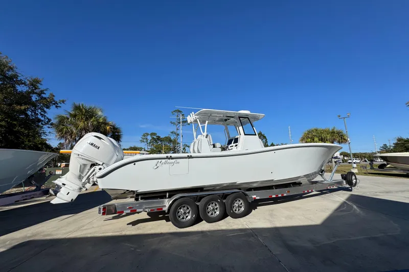 Slide: The Image of 2026 Yellowfin 36 Offshore boat on trailer under clear blue sky. - 13