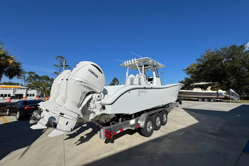 Slide: The Image of 2026 Yellowfin 36 Offshore boat with Yamaha engines on a trailer, parked outdoors. - 14