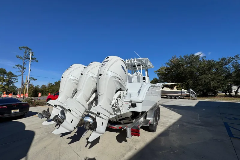 Slide: The Image of 2026 Yellowfin 36 Offshore boat with triple Yamaha outboard engines, parked outdoors. - 15