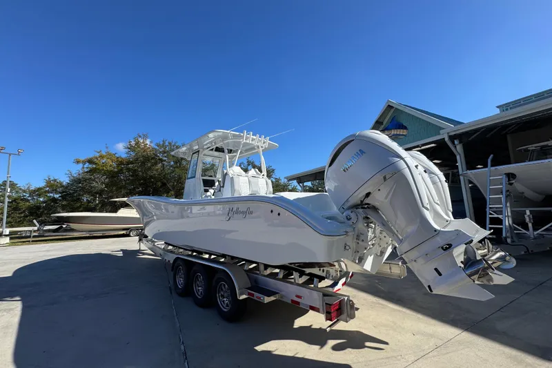 Slide: The Image of 2026 Yellowfin 36 Offshore boat with Yamaha engine on trailer under clear blue sky. - 18