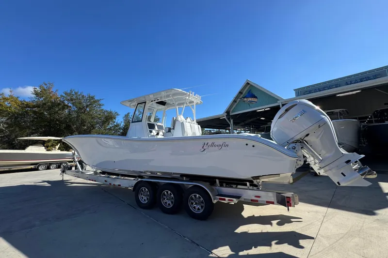 Slide: The Image of 2026 Yellowfin 36 Offshore boat on trailer, parked outside a marine facility. - 19