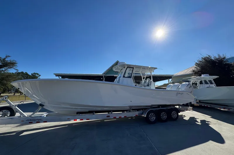 Slide: The Image of 2026 Yellowfin 36 Offshore boat on trailer under clear blue sky. - 2
