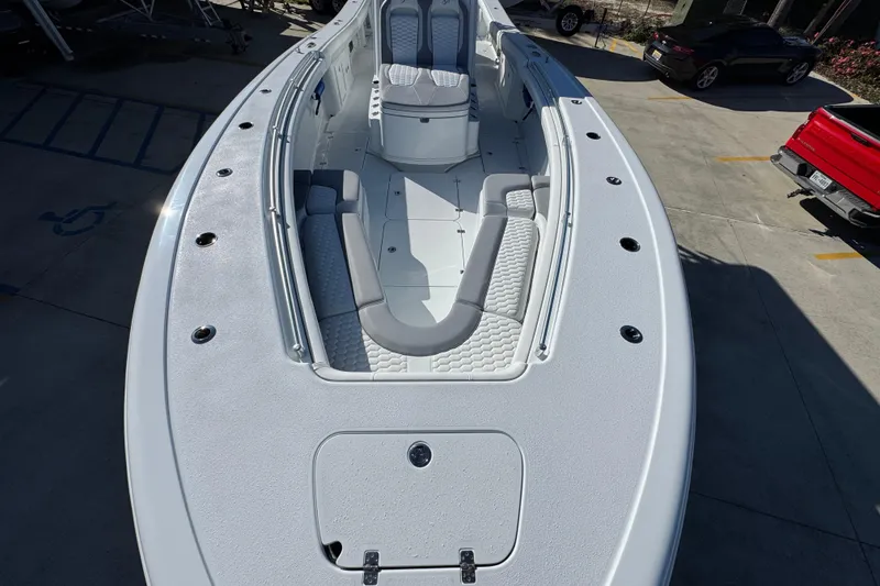 Slide: The Image of 2026 Yellowfin 36 Offshore boat with spacious deck and seating, parked outdoors. - 23