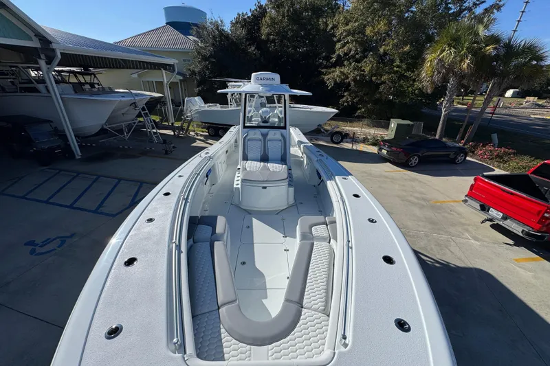 Slide: The Image of 2026 Yellowfin 36 Offshore boat in a marina, showcasing spacious deck and seating. - 24