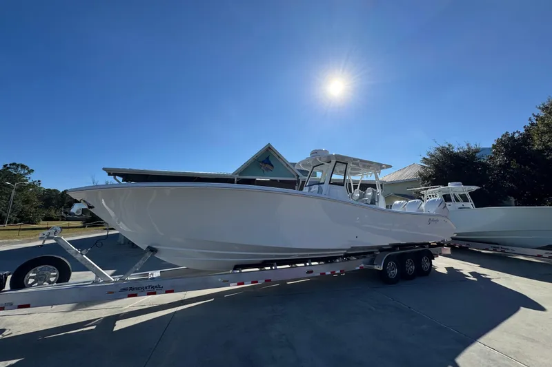 Slide: The Image of 2026 Yellowfin 36 Offshore boat on trailer under clear blue sky. - 3