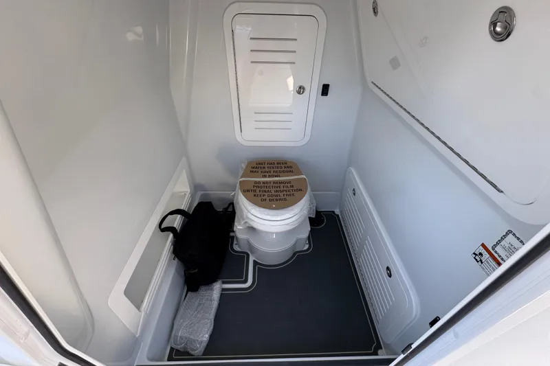 Slide: The Image of 2026 Yellowfin 36 Offshore boat bathroom interior with toilet and storage compartments. - 30