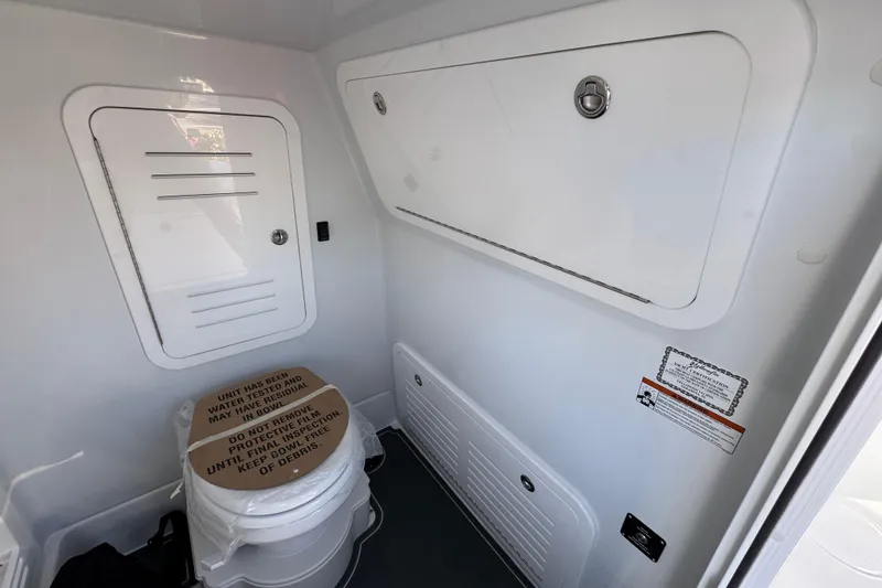 Slide: The Image of 2026 Yellowfin 36 Offshore boat interior with storage compartments and toilet. - 31