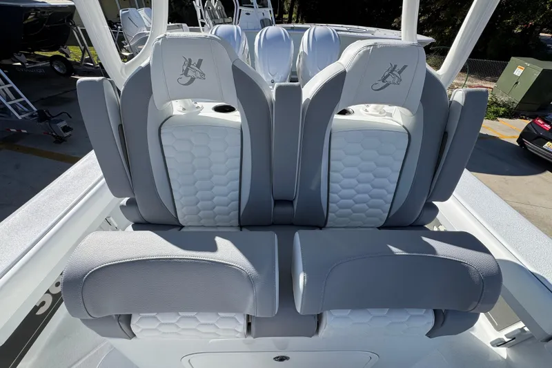 Slide: The Image of 2026 Yellowfin 36 Offshore boat seats with gray and white upholstery, featuring a hexagonal pattern. - 33