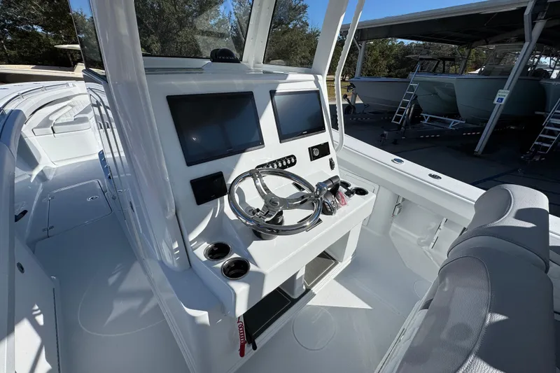 Slide: The Image of 2026 Yellowfin 36 Offshore boat cockpit with modern steering and dual screens. - 35