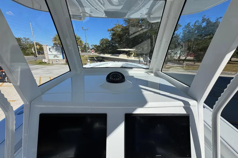 Slide: The Image of 2026 Yellowfin 36 Offshore boat cockpit with dual screens and compass, showcasing modern navigation features. - 37