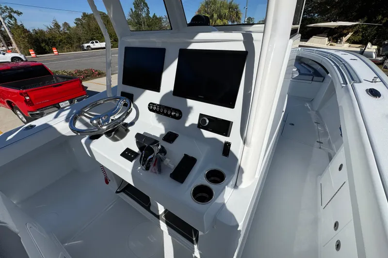 Slide: The Image of 2026 Yellowfin 36 Offshore boat cockpit with dual screens and steering wheel. - 39